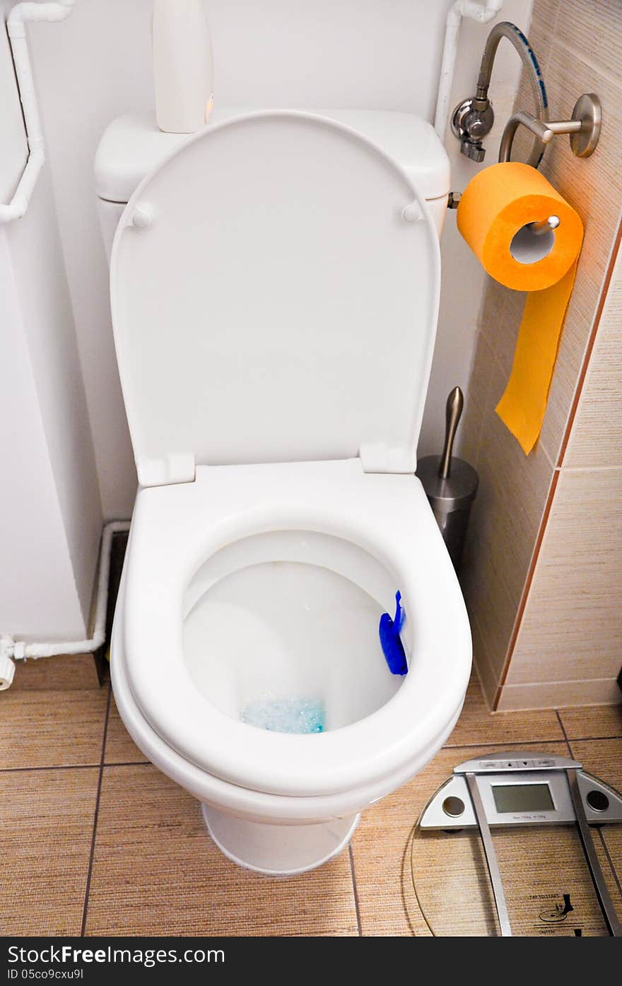 White Toilet with orange paper