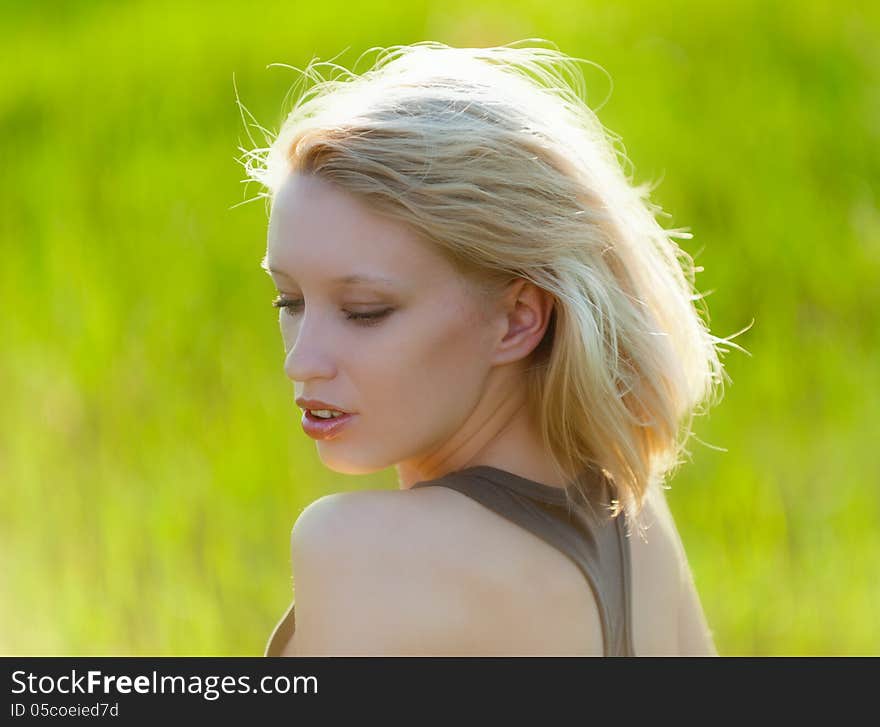 Portrait of the young beautiful blond woman outdoors