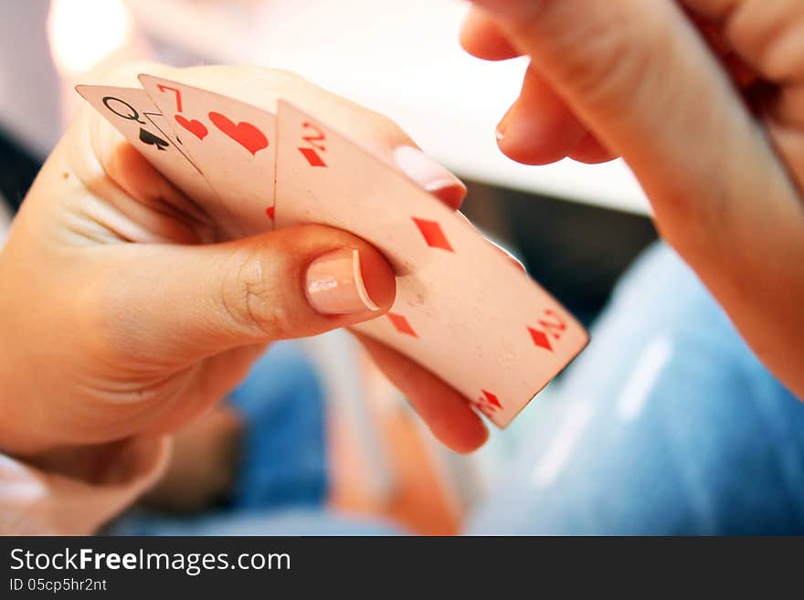 Woman hand holding three playing cards. Woman hand holding three playing cards