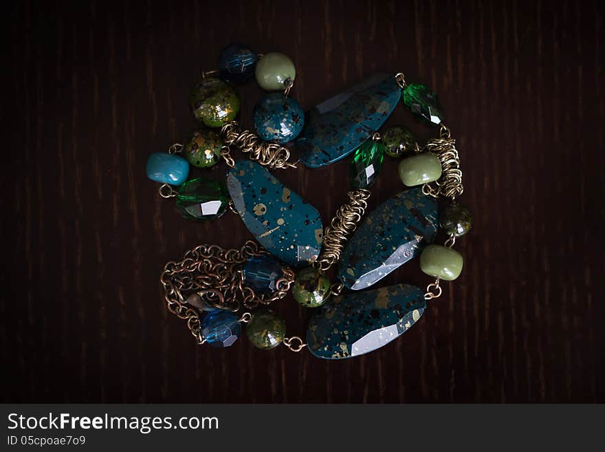 Elegant ornament from a multi-colored beads against a dark background