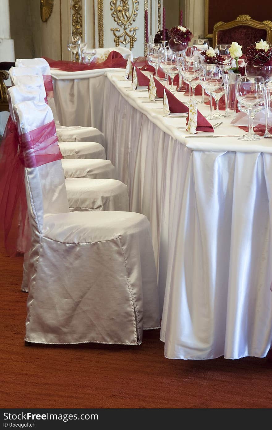 Tables set up for a formal wedding reception in a luxury room. Tables set up for a formal wedding reception in a luxury room.