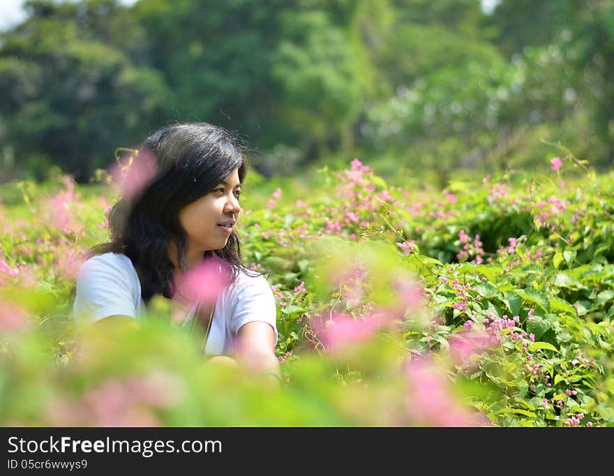 Young woman sitting in green rural field