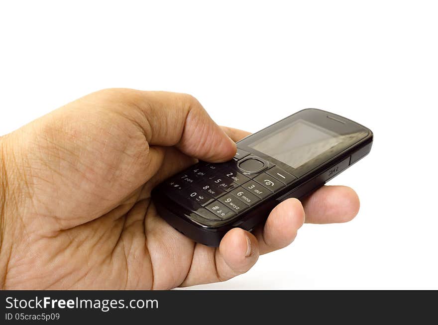 Cell phone in hand against white background.