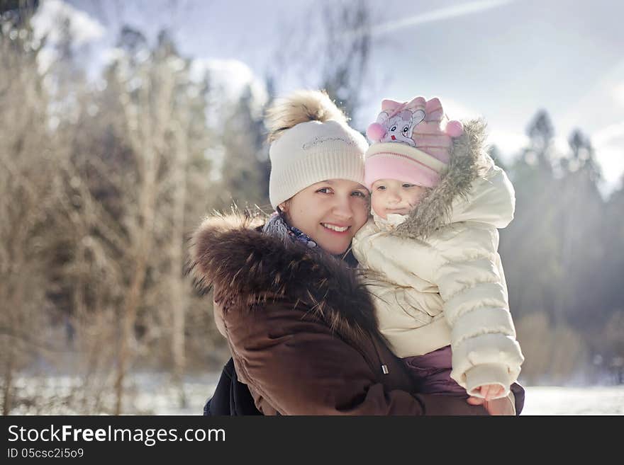 Winter outdoor portrait of mother and baby. Winter outdoor portrait of mother and baby