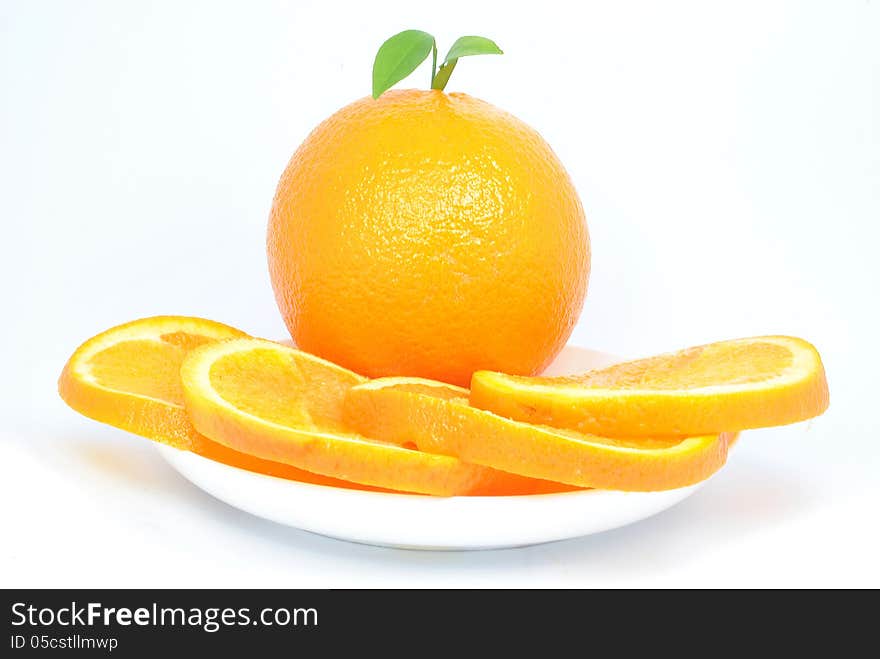 Orange and orange pieces on a plate and white background. Orange and orange pieces on a plate and white background