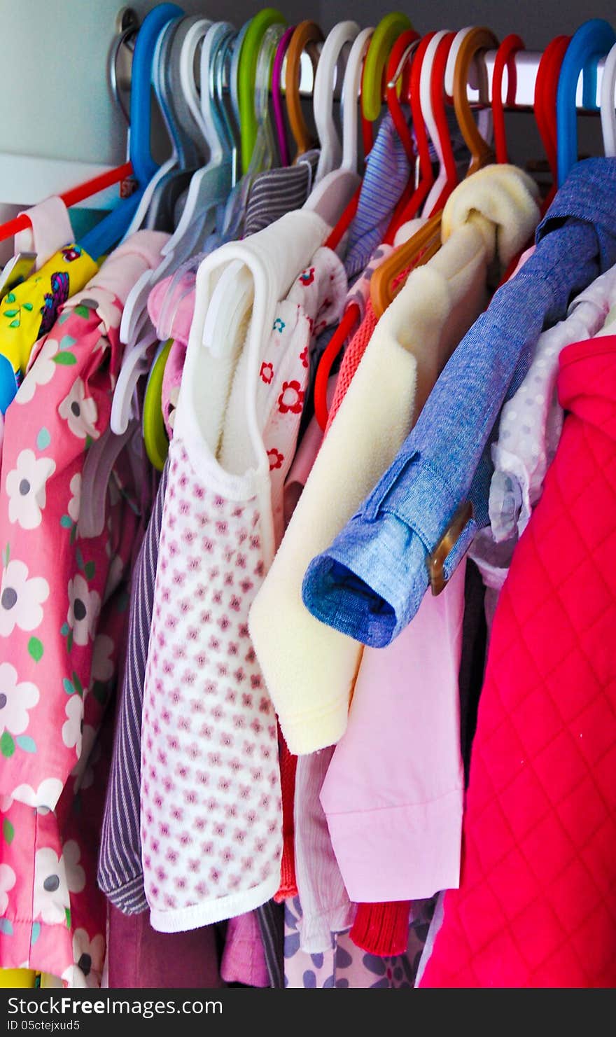 Lovely little girl dresses hanged in the closet