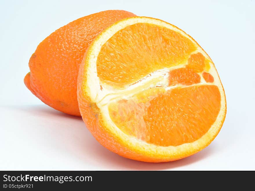 Juicy orange pieces next to each other on a white background. Juicy orange pieces next to each other on a white background