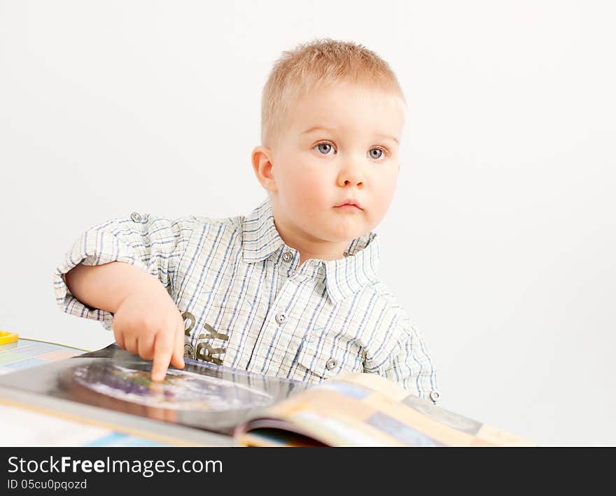 curious baby boy studying with the book