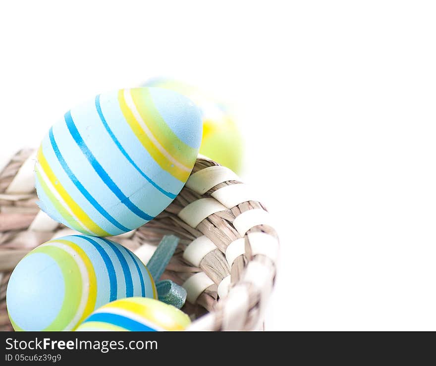 Easter eggs in basket isolated on white