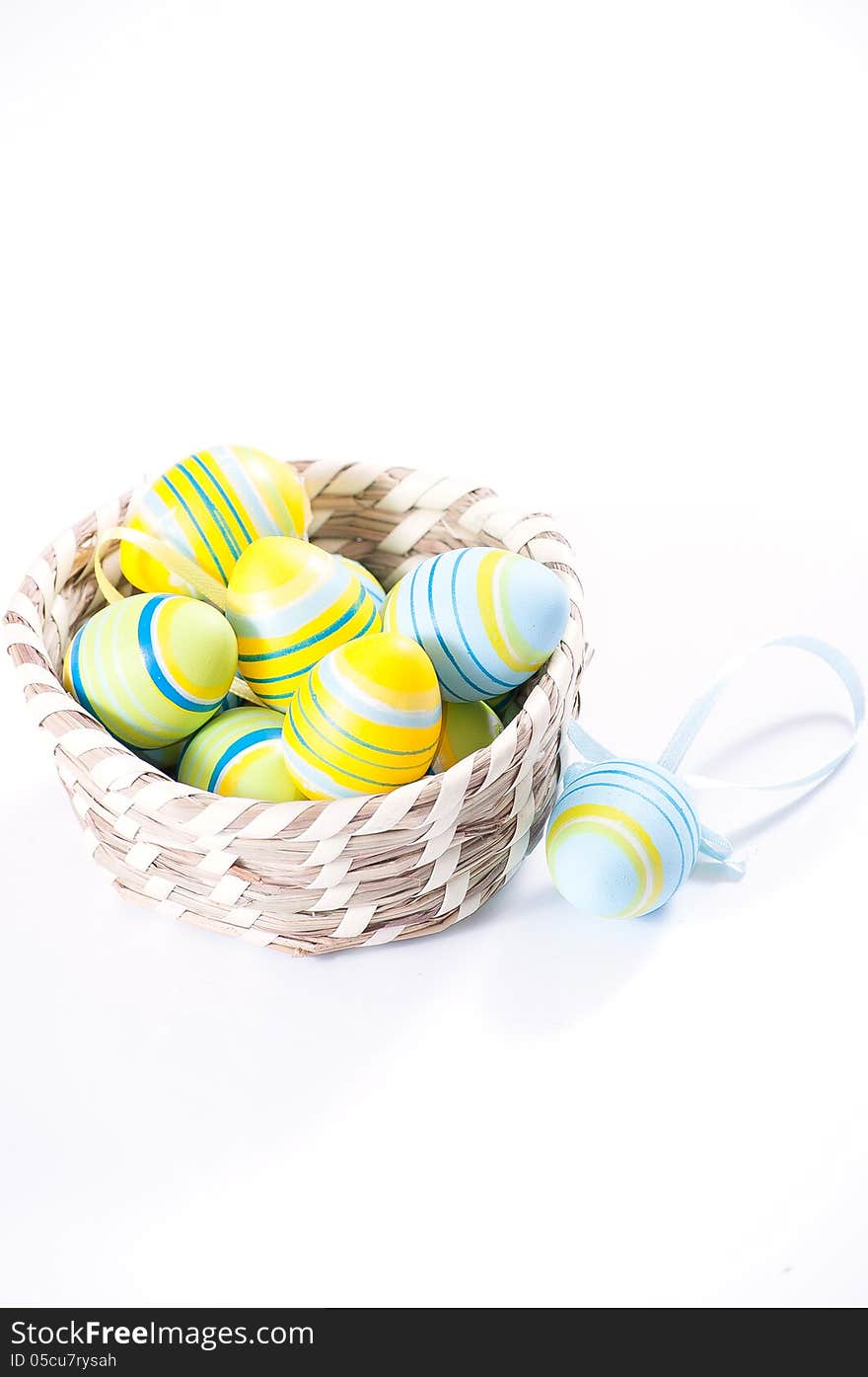 Easter eggs in basket isolated on white