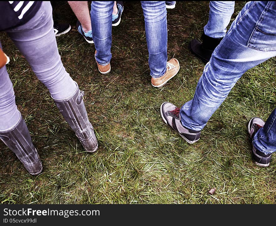 Shoes on grass from people watching a concert