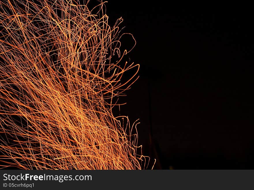 Fire sparks fly top on black background