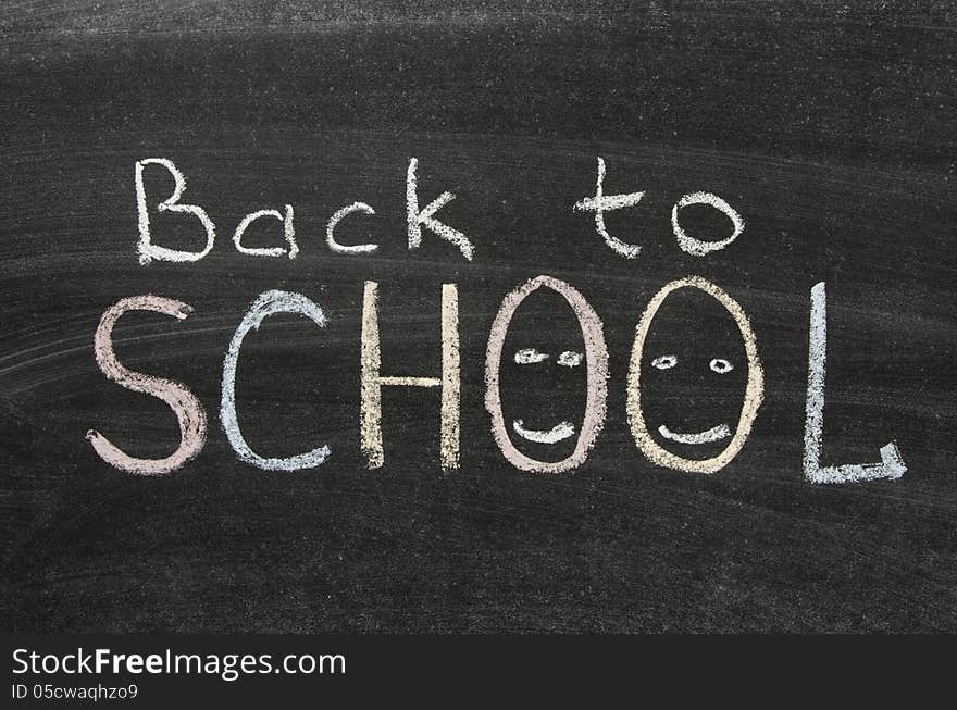 Back to school phrase handwritten on blackboard