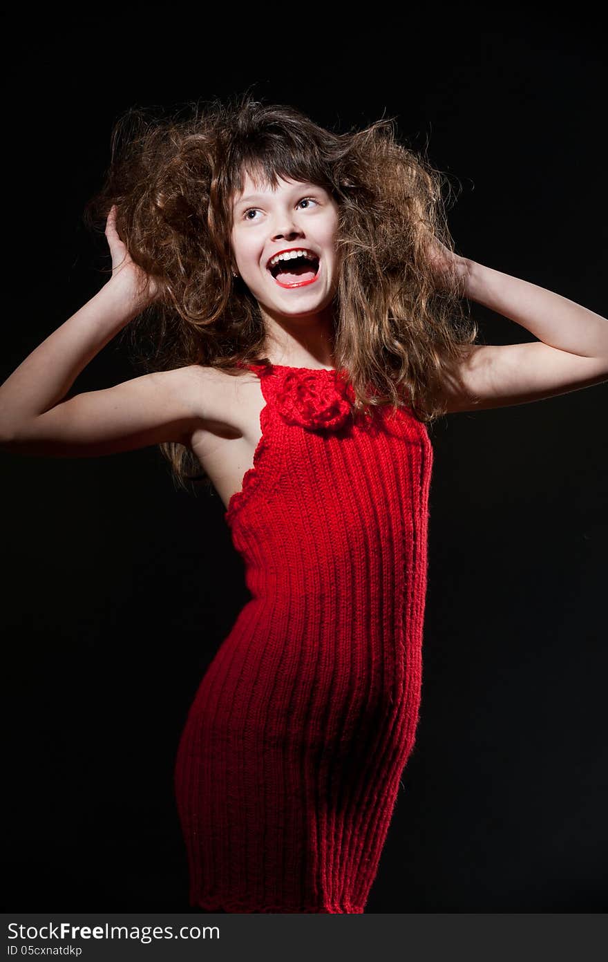 Young girl in a red dress shouting. Young girl in a red dress shouting