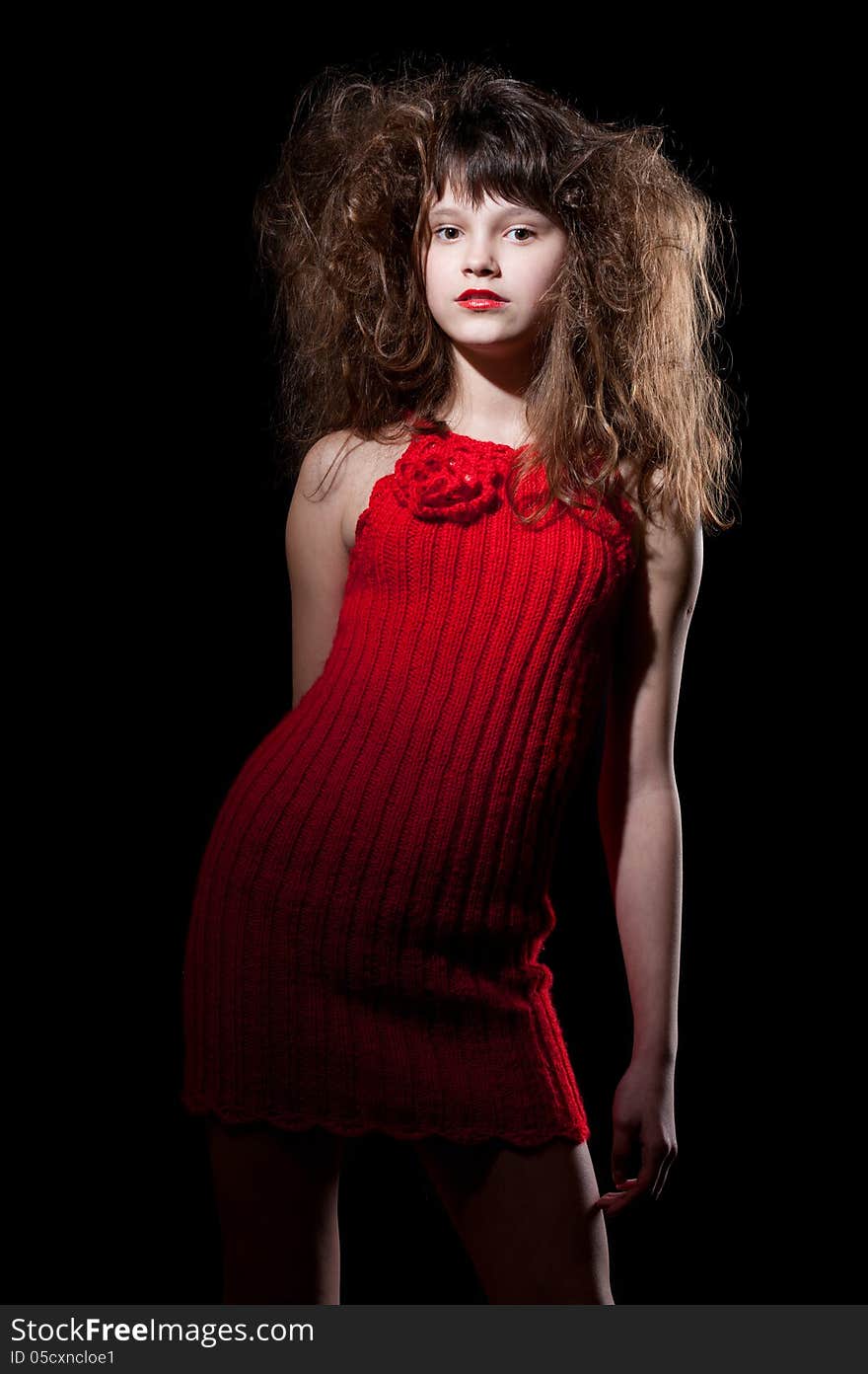 Young girl in a red dress on black, isolated. Young girl in a red dress on black, isolated