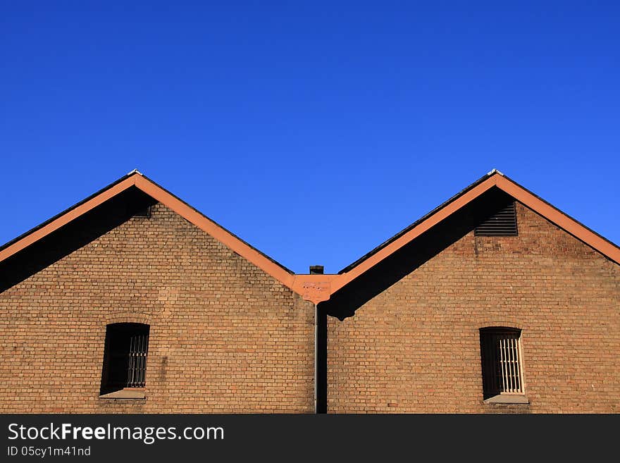 Contrast orange wall brick with blue sky. Contrast orange wall brick with blue sky.