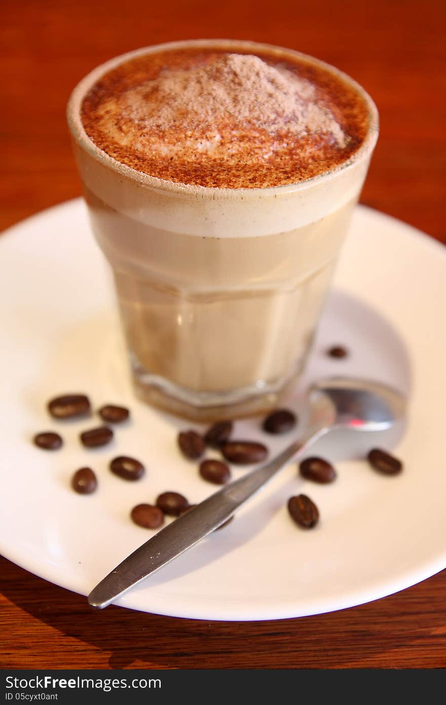 Coffee and coffee beans in clear glass. Coffee and coffee beans in clear glass.