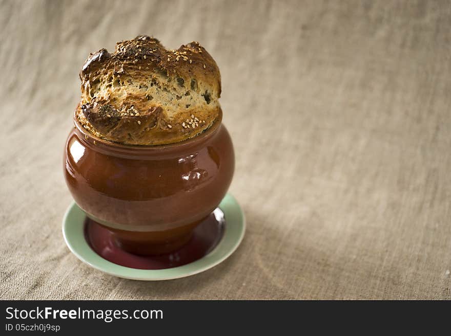 Bread covering of a casserole with fennel and sesame on the top