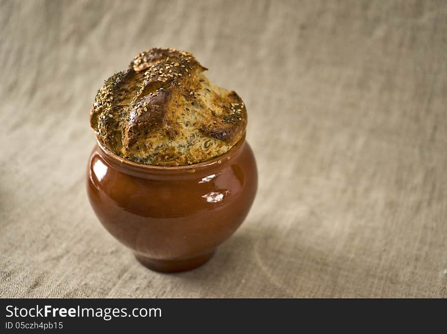 Bread covering of a casserole with fennel and sesame on the top