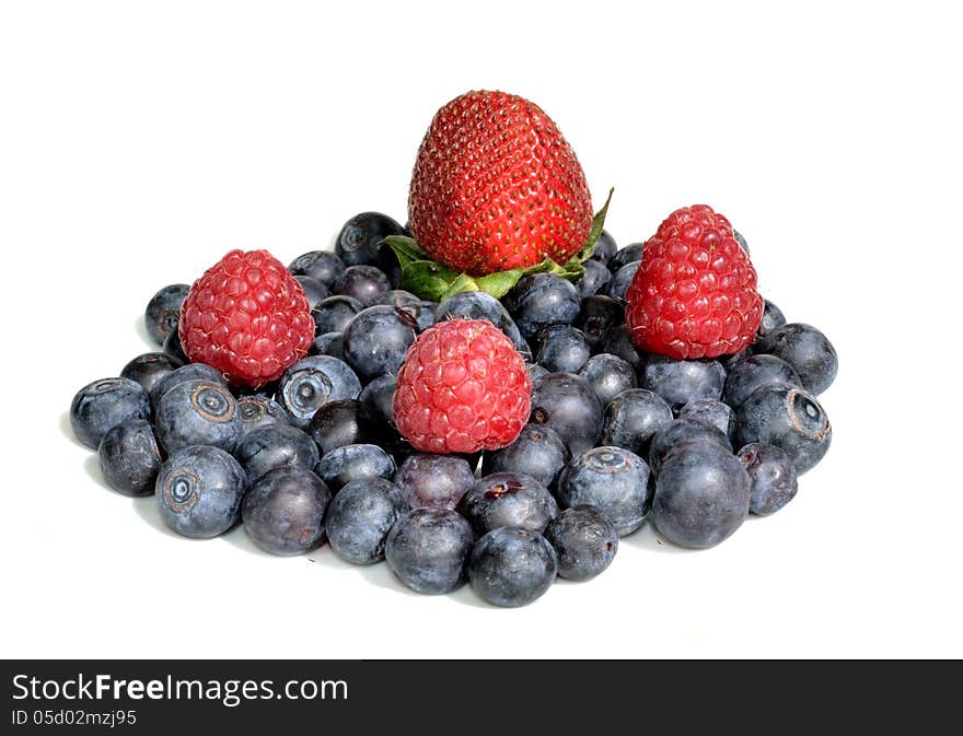 Strawberry and three raspberries sitting on a group of blueberries. Strawberry and three raspberries sitting on a group of blueberries.