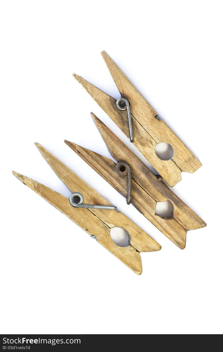 Three old wooden clothespin isolated over white