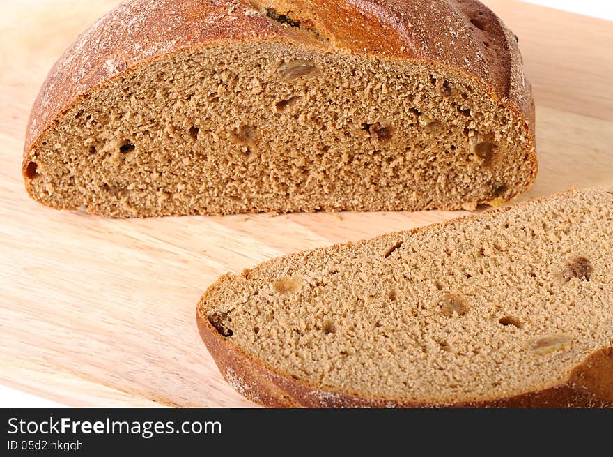 Bread with raisin on a cutting board, closeup