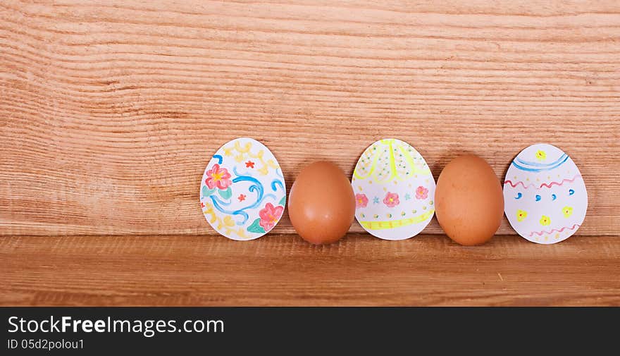 On a wooden background painted eggs for Easter. On a wooden background painted eggs for Easter