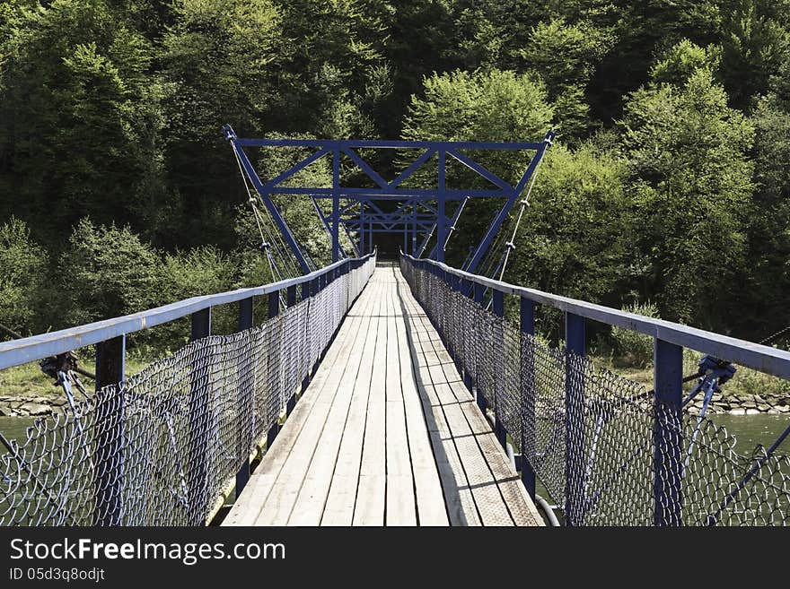 Creative Commons presents hanging over the river footbridge for pedestrians. Creative Commons presents hanging over the river footbridge for pedestrians