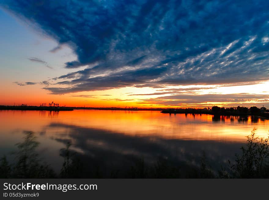 It is Daqing oil field scenery.Heilongjiang province,china.The clouds pointing oil well. It is Daqing oil field scenery.Heilongjiang province,china.The clouds pointing oil well.