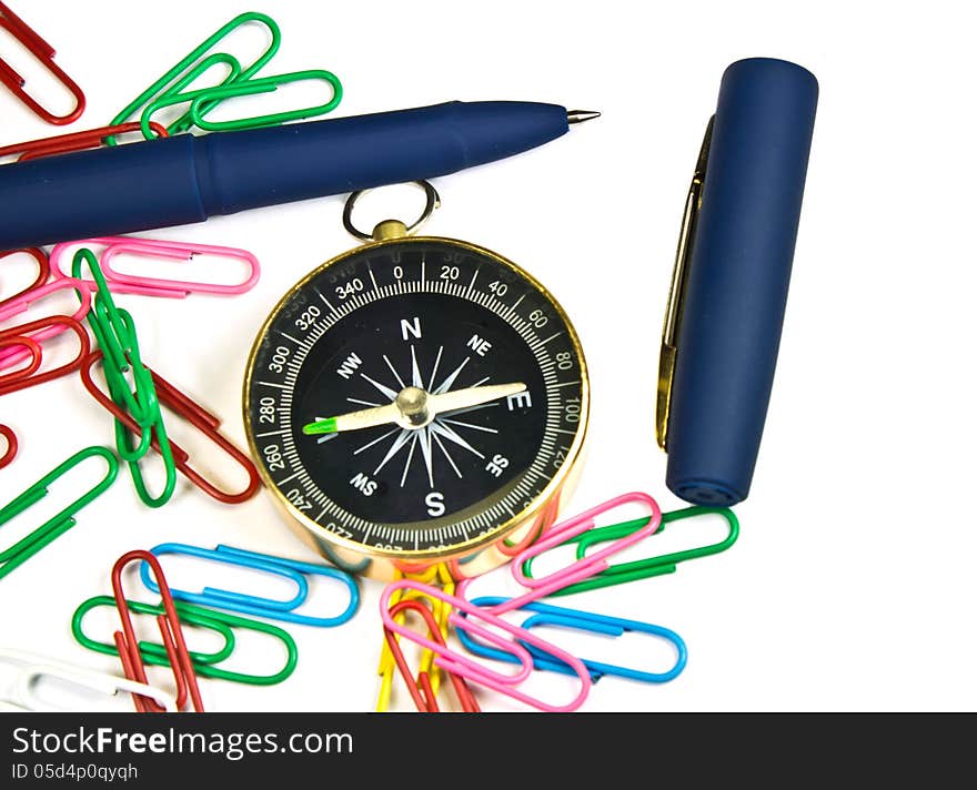 Paper clips, pens, compass on white background