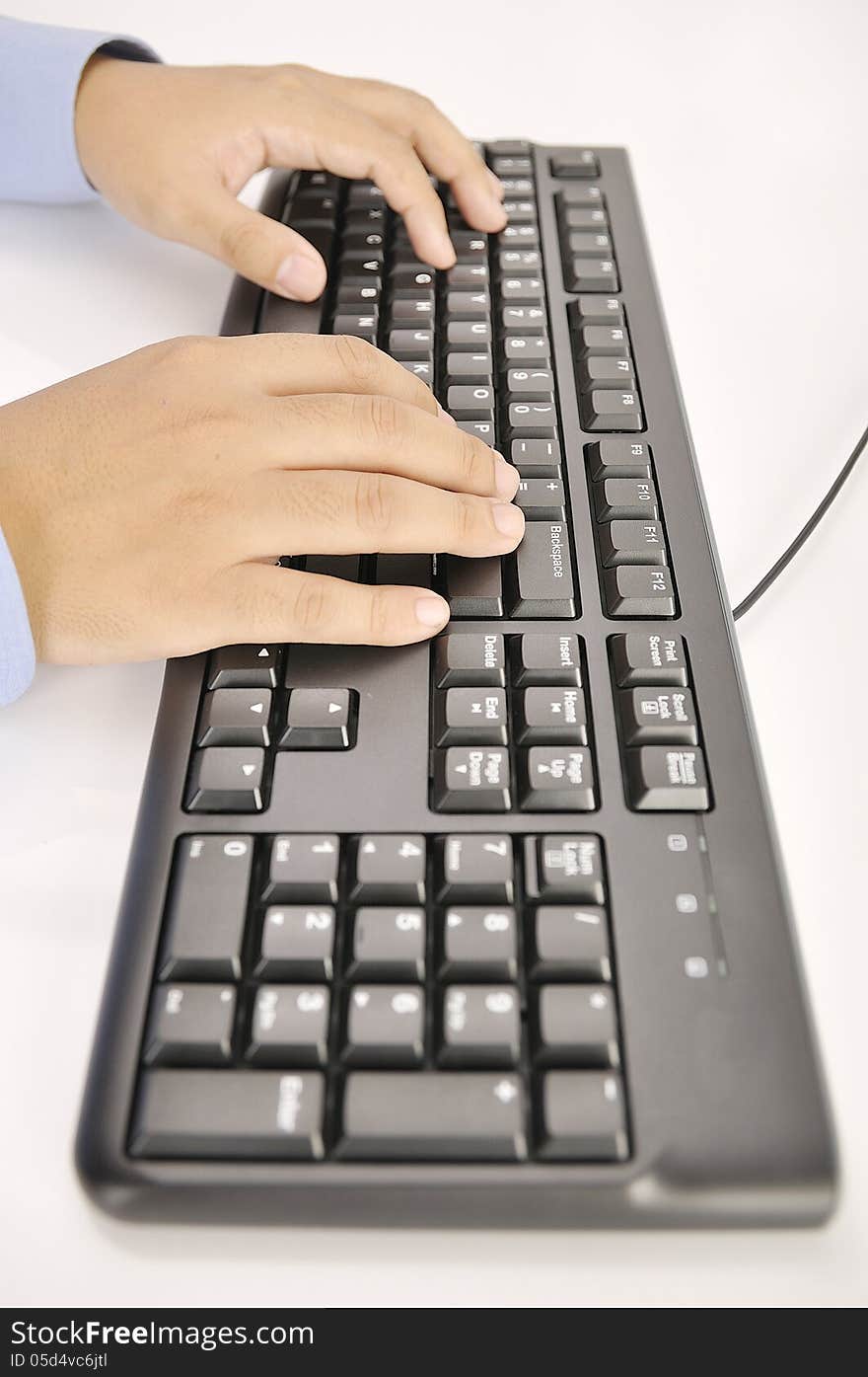 Hands typing on keyboard. This is office environment concept