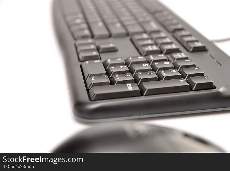 Computer mouse and keyboard on white background