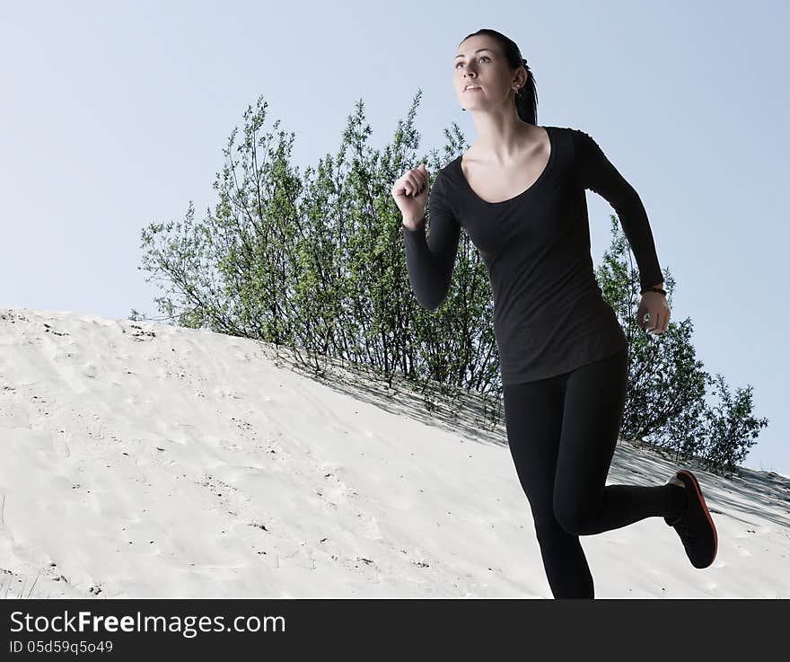 Woman In Black Running Over Sand Dunes