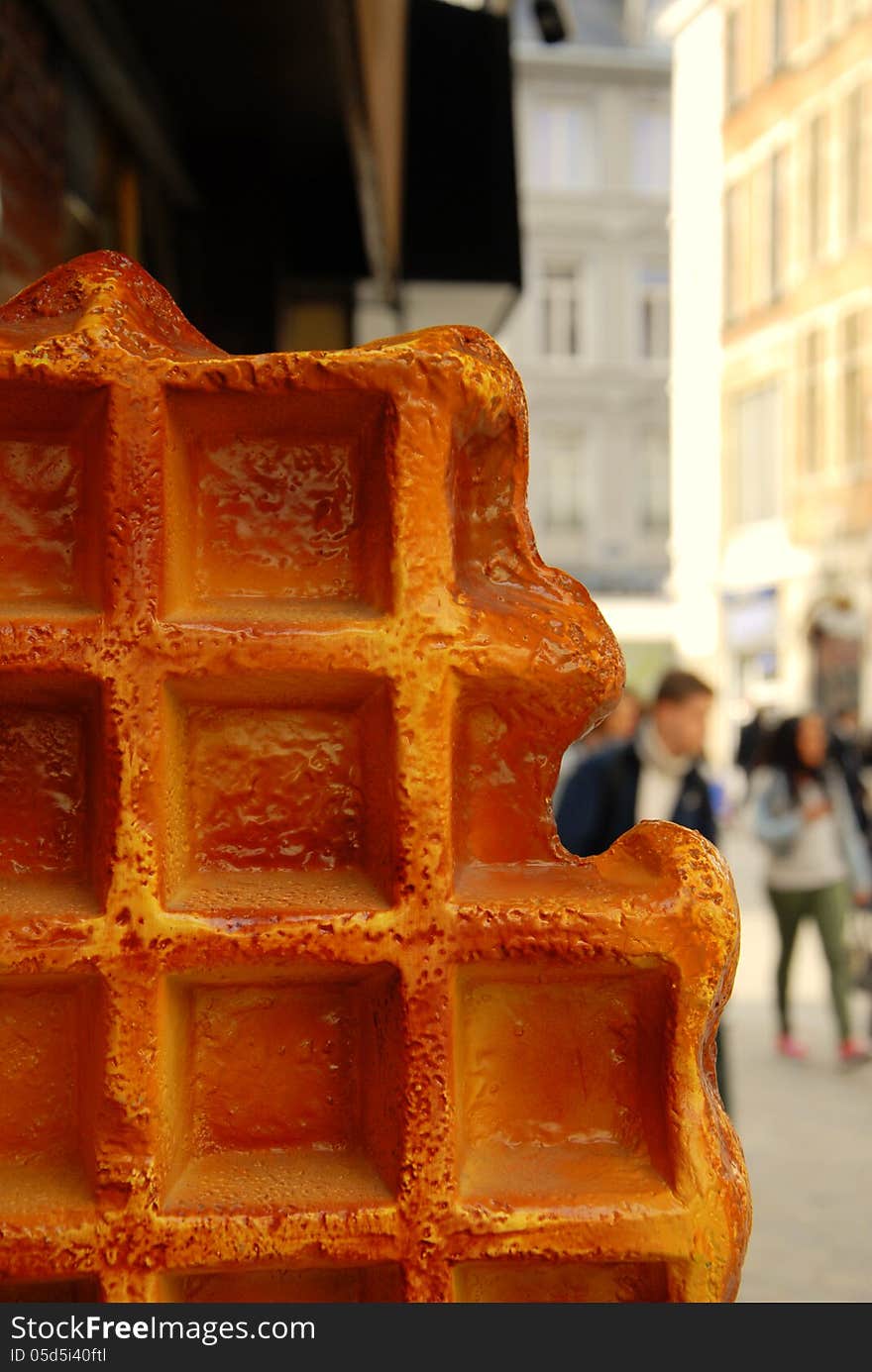 Big waffel on the road with blurred cityscape on background