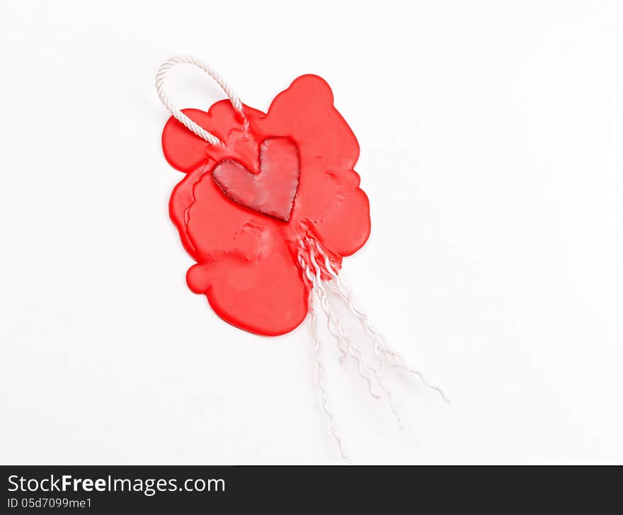 Mark in the shape of a heart made of red sealing wax