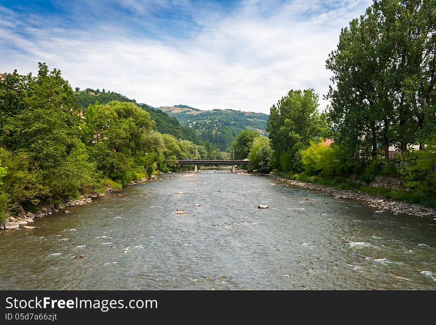 Landscape with mountains trees and a bridge through river. Landscape with mountains trees and a bridge through river