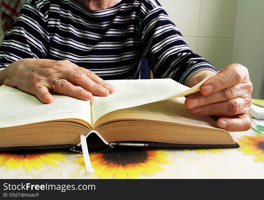 A Senior Woman Reading A Book