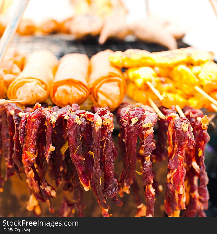 Thai food. Dry beef meat and spring rolls