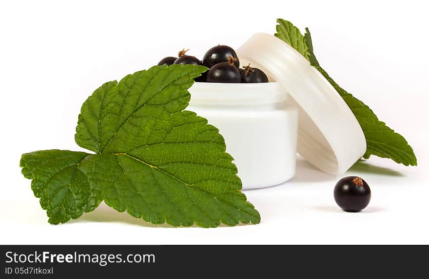 Black currants in a jar of makeup with green leaves. Black currants in a jar of makeup with green leaves