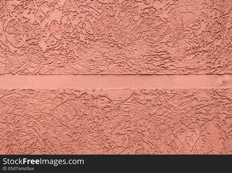 Pink textured plaster with a smooth strip in the middle. Pink textured plaster with a smooth strip in the middle