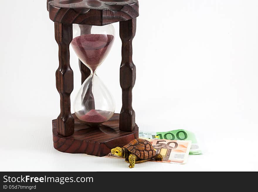 Hourglass and money with a turtle