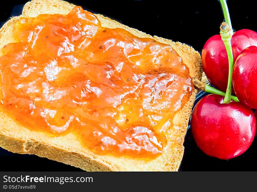 Jam, cherries and bread for a healty breakfast