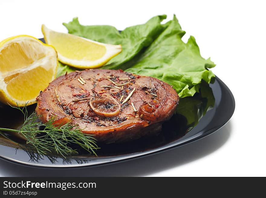 Grilled steak with salad and lemon