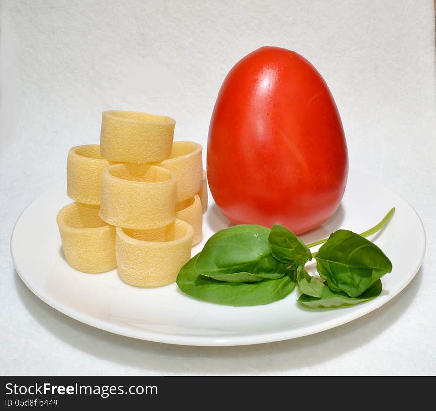 Pasta And Basil Leaves And A Tomato