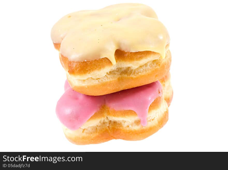 Two Doughnuts with banana and strawberry glaze isolated on white. Two Doughnuts with banana and strawberry glaze isolated on white