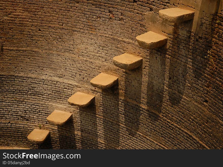 A Portion Of A Circular Old Well With Steps Inside