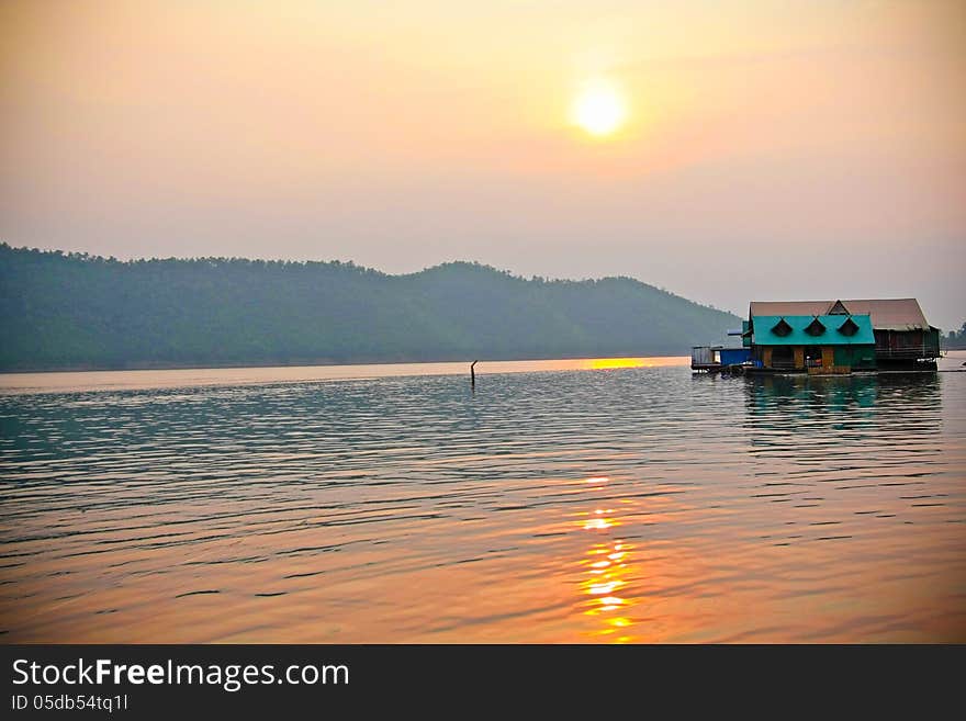 Sun set in a lake with floating house