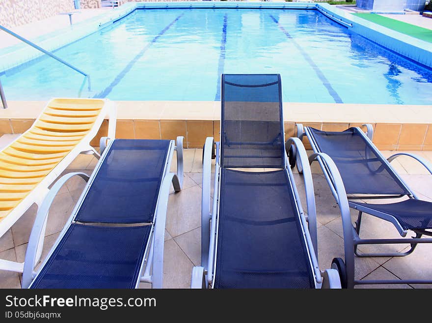 Pool with fresh and clear water and sunbeds. Pool with fresh and clear water and sunbeds