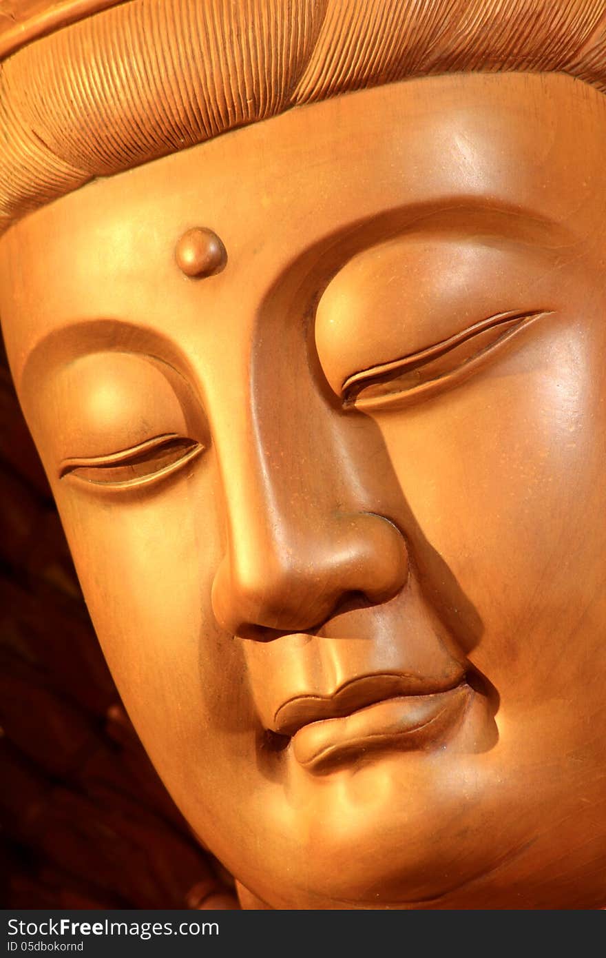 A wooden Guan-Yin statue in a Chinese temple. A wooden Guan-Yin statue in a Chinese temple.