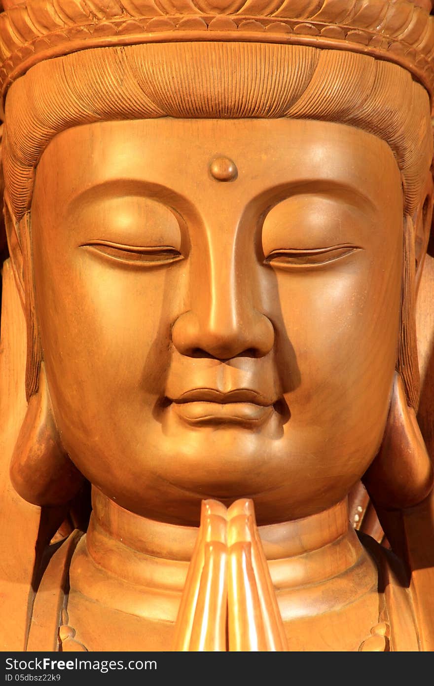 A wooden Guan-Yin statue in a Chinese temple. A wooden Guan-Yin statue in a Chinese temple.